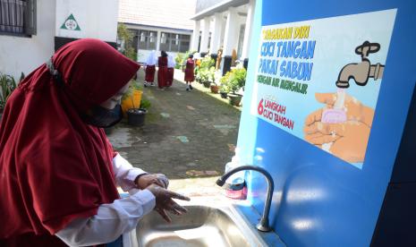 Pelajar mencuci tangan sebelum masuk kelas saat pelaksanaan Pembelajaran Tatap Muka (PTM) secara penuh di SDN 033 Jalan Asmi, Kota Bandung.