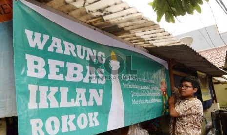 Pelajar SMPN 104 Jakarta menurunkan iklan rokok di warung-warung di dekat sekolah, Jakarta Selatan, Kamis (5/11). (Republika/Yasin Habibi)