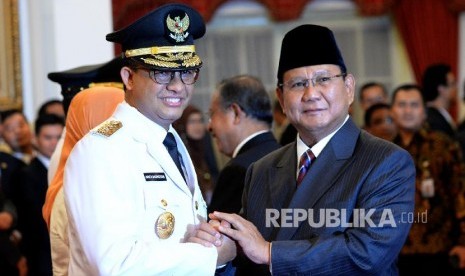 Anies Baswedan receives greeting from Gerindra chairman Prabowo Subianto after being inaugurated as Jakarta governor by President Joko Widodo at State Palace, Jakarta.