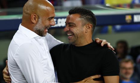   Pelatih Barcelona Xavi Hernandez (kanan) menyapa pelatih Manchester City yang juga mantan pelatih Barcelona, Pep Guardiola, belum lama ini.