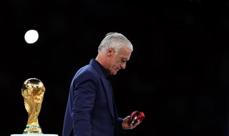  Pelatih kepala Prancis Didier Deschamps melewati trofi Piala Dunia dengan medali peraknya setelah Final Piala Dunia FIFA 2022 antara Argentina dan Prancis di stadion Lusail, Lusail, Qatar,  Ahad (18/12/2022).