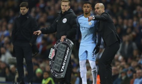 Pelatih Manchester City, Pep Guardiola (kanan) memberikan instruksi kepada Gabriel Jesus pada laga debutnya bersama City saat laga melawan Tottenham Hotspur, Sabtu (21/1).