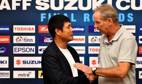 Pelatih tim nasional Indonesia Alfred Riedl (kanan) berbincang dengan pelatih tim nasional Vietnam Nguyen Huu Thang (kiri) usai memberikan keterangan pers jelang pertandingan Vietnam melawan Indonesia pada babak semi final putaran kedua AFF Suzuki Cup 2016