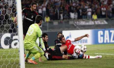 Pemain Arsenal, Olivier Giroud (kanan), berebut bola dengan pemain Besiktas di leg kedua babak playoff Liga Champions di Istanbul, Turki, Selasa (19/8). 