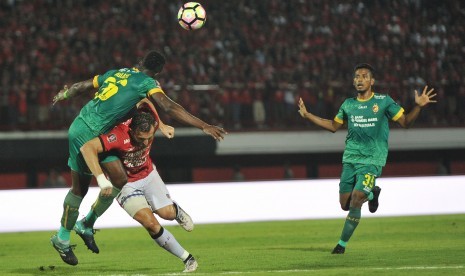 Pemain Bali United, Ilija Spasojevic (tengah), berebut bola dengan pemain Sriwijaya FC, Mahamadou N'Diaye (kiri), dalam pertandingan babak Semifinal Leg 2 Piala Presiden 2018 di Stadion I Wayan Dipta, Gianyar, Bali, Rabu (14/2). 