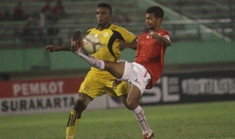 Pemain Barito Putra, Coulibaly Djibril (kiri) saling berebut bola dengan pemain Persija Jakarta, Syahrizal,