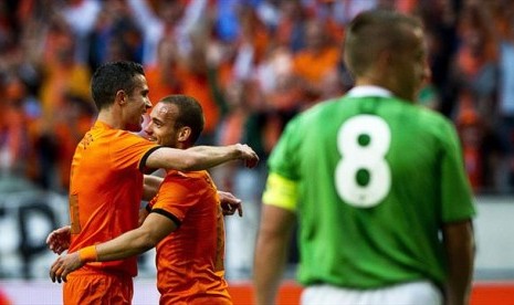 Pemain Belanda merayakan kemenangan