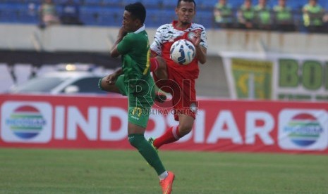 Pemain dari kesebelasan Persebaya Ario Wage (kiri) berebut bola dengan pemain Martapura FC Pahreza Agamal (depan) pada pertandingan penyisihan grup A Piala Presiden 2015 di stadion Si Jalak Harupat, Kabupaten Bandung, Rabu (2/9). 