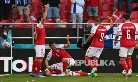 Pemain Denmark Christian Eriksen menerima perawatan medis setelah pingsan pada pertandingan grup B kejuaraan sepak bola Euro 2020 antara Denmark dan Finlandia di stadion Parken di Kopenhagen, Sabtu (12/6).