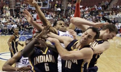 Pemain Indiana Pacers (hitam) mengepung pemain lawan yang coba melepaskan tembakan dalam di laga NBA.