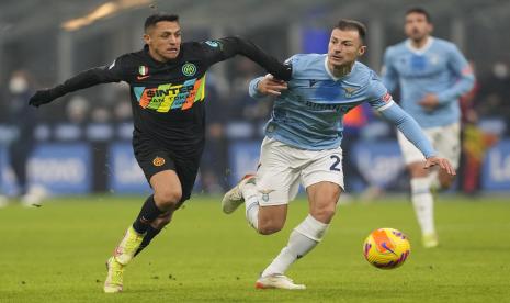 Pemain Inter Milan Alexis Sanchez, kiri, dan pemain Lazio Stefan Radu berebut bola selama pertandingan sepak bola Serie A antara Inter Milan dan Lazio di Stadion San Siro, di Milan, Italia, Ahad 9 Januari 2022.