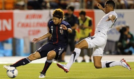  Pemain Jepang, Yuki Otsu (kiri) berebut bola dengan pemain Selandia Baru, James Musa dalam pertandingan persahabatan di Tokyo, 11 Juli 2012