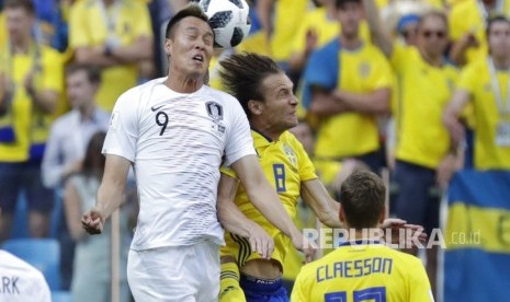 Pemain Korea Selatan Kim Shin-wook  dan Pemain Swedia  Albin Ekdal  menyundul bola pada pertandingan grup F Piala Dunia 2018  antara Swedia dan Korea Selatan di stadion Nizhny Novgorod , Rusia, Senin (18/6). 