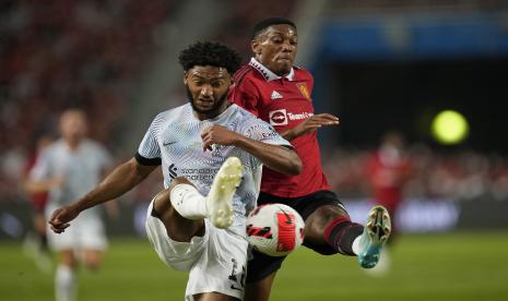  Pemain Liverpool Joe Gomez (kiri) berebut bola dengan pemain Manchester United Anthony Martial saat pertandingan pramusim di stadion nasional Rajamangala di Bangkok, Selasa, 12 Juli 2022. Manchester United mengalahkan Liverpool 4-0.