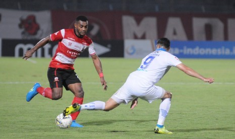 Pemain Madura United (MU) Markho Sandi (kiri) berusaha melewati gelandang Persib Bandung Esteban Vizcarra pertandingan Liga 1 di Stadion Gelora Bangkalan (SGB) Madura, Sabtu (5/10).