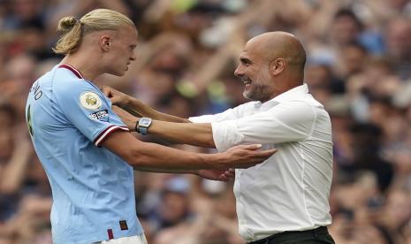  Penyerang Manchester City Erling Haaland bersama pelatihnya Pep Guardiola.