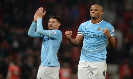 Pemain Manchester City Vincent Kompany (kanan) dan Javi García (kiri), usai menundukkan Manchester United dengan skor 3-0, Selasa (25/3).