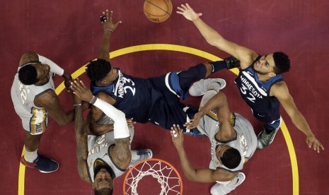 Pemain Minnesota Timberwolves, Karl-Anthony Towns (kanan), coba mengambil bola saat menghadapi Cleveland Cavaliers di laga basket NBA di Cleveland pada Rabu (7/2). 