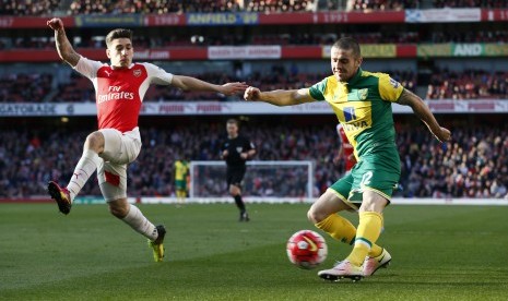 Pemain Norwich Robbie Brady beraksi melawan pemain Arsenal Hector Bellerin dalam laga di Barclays Premier League, Emirates Stadium, (30/4).