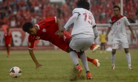 Pemain Persis Solo Dedi Cahyo Putro dijegal (kiri) dijegal Elad Hendri Njobi dari Martapura FC Kalsel.