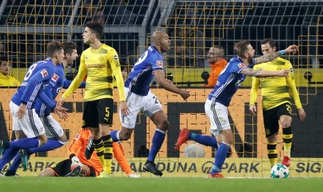 Pemain Schalke Naldo (tengah) merayakan gol ke gawang Borussia Dortmund pada pertandingan Bundesliga, Sabtu (25/11).