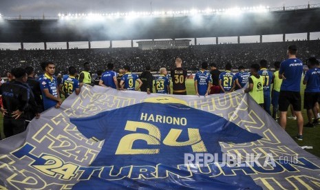 Pemain sekaligus ofisial Persib Bandung membentangkan spanduk raksasa bergambar kostum Hariono saat seremoni perpisahan Hariono usai pertandingan lanjutan Liga 1 2019 melawan PSM Makassar di Stadion Si Jalak Harupat, Kabupaten Bandung, Ahad (22/12).