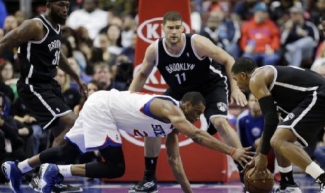 Pemain Sixers Thaddeus Young jatuh dan kehilangan bola saat akan menyerang Brooklyn Nets 