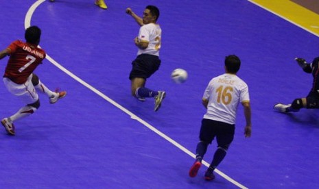 Pemain timnas futsal putra Indonesia Jaelani Laojanibi (kiri) melepaskan tendangan pada pertandingan futsal putra Group A Indonesia vs Filipina Sea Games XXVI di GOR Popki, Jakarta, Jum'at (18/11). Indonesia menang dengan skor 9-5 dan memastikan melaju ke 