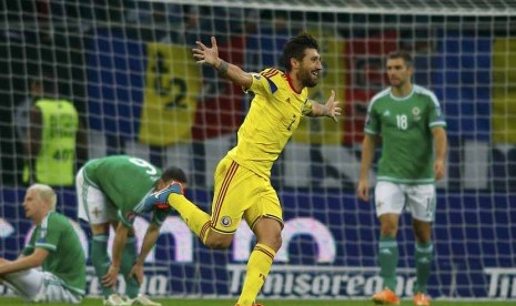 Pemain Timnas Rumania, Paul Papp (tengah), melakukan selebrasi usai menjebol gawang Irlandia Utara di laga Grup F kualifikasi Piala Eropa 2016 di Stadion Nasional, Bukares, Jumat (14/11). 