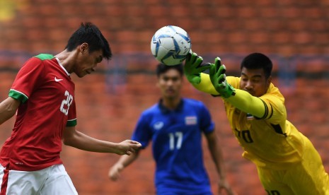 Pemain Timnas U-22 Septian David Maulana (kiri) menyundul bola ditahan kiper Timnas Thailand U-22 Nont Muangngam (kanan) dalam penyisihan grup B SEA Games XXIX Kuala Lumpur 2017 di Stadion Shah Alam, Selangor, Malaysia, Selasa (15/8). 