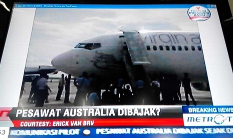 Berita pembajakan maskapai Virgin Australia di televisi.