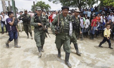 Pemimpin pemberontak FARC, Jairo (tengah), berjalan di San Isidro, Kolombia, Rabu (30/5). 