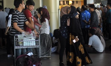 Pemudik disambut keluarganya saat tiba di terminal kedatangan Bandara Internasional Minangkabau (BIM), Padangpariaman, Sumatra Barat, Kamis (22/6).