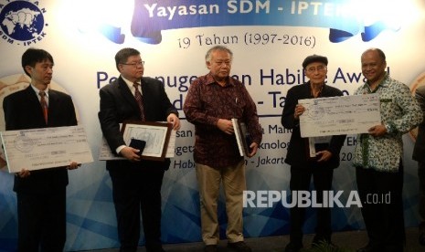 Pendiri Yayasan SDM IPTEK Habibie Center Ilham Habibie (kanan) memberikan hadiah kepada Budayawan Sapardi Djoko Damono, bersama Guru Besar FMIPA ITB Hendra Gunawan (dari kiri), Peneliti Farmasi Raymond Rubianto Tjandrawinata, dan Guru Besar Sekolah Arsitek