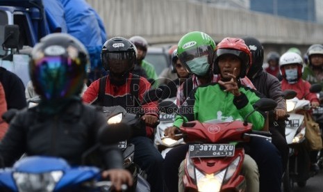  Pengemudi ojek online membawa penumpang saat melintasi Kawasan Kota Kasablanka, Jakarta Selatan, Jumat (18/12).