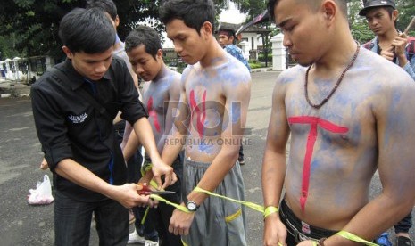  Pengguntingan ikatan sebagi simbol merdekanya Banten dari dinasti politik Ratu Atut pada aksi peduli Banten di depan Gedung Sate, Bandung, Kamis (19/12).   (Republika/Edi Yusuf)