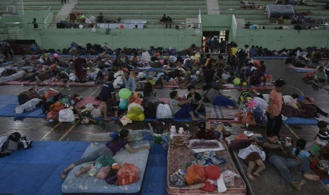 Pengungsi Gunung Agung beristirahat di GOR Suwecapura, Klungkung, Bali, Minggu (24/9) malam.