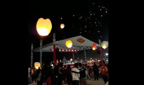 Pengunjung Ancol menyalakan lampion di Pantai Lagoon, Jakarta, Jumat (16/2).