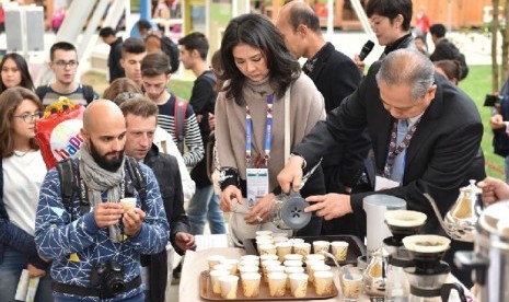 Pengunjung berbagai negara menghadiri acara International Coffee Day di Paviliun Indonesia.