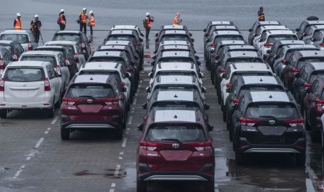 Pengunjung berjalan di dekat mobil baru siap ekspor yang terparkir di PT Indonesia Kendaraan Terminal atau IPC Car Terminal, Cilincing, Jakarta, Senin (18/3/2019). 