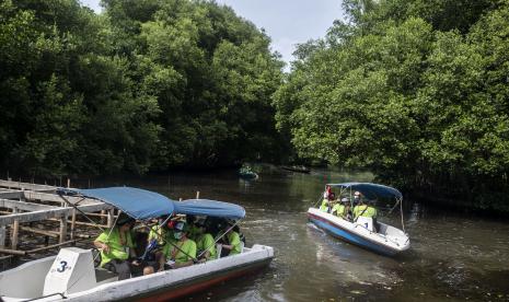 Pengunjung menaiki perahu saat menyusuri Hutan Mangrove di Taman Wisata Alam Mangrove Angke Kapuk, Jakarta. Pemerintah Provinsi (Pemprov) DKI Jakarta telah mempersiapkan lokasi-lokasi wisata untuk mengisi waktu libur Lebaran Idul Fitri 1444 Hijriyah/ 2023 Masehi. Penjabat (Pj) Gubernur DKI Jakarta Heru Budi Hartono mengajak masyarakat agar memanfaatkan sejumlah tempat wisata yang disediakan.