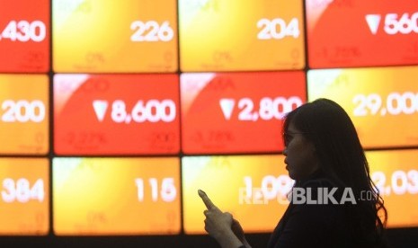 Pengunjung mengamati pergerakan Indeks Harga Saham Gabungan (ilustrasi). 