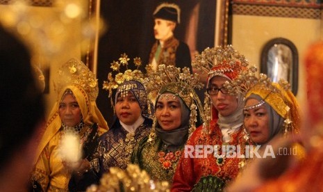 Pengunjung mengenakan pakaian adat melayu berfoto di dalam Istana Maimun, Medan, Sumatera Utara, Kamis (28/4).Republika/Rakhmawaty La'lang