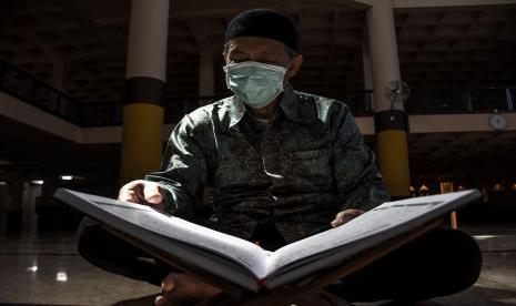 Pengurus Dewan Kemakmuran Masjid (DKM) membaca Al Quran di Masjid Raya Bandung yang ditutup di Jalan Dalem Kaum, Kota Bandung.