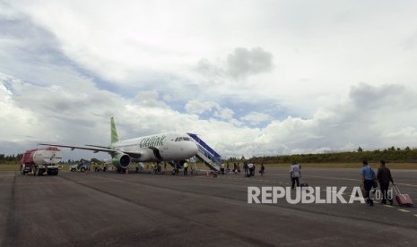 Penumpang maskapai Citilink dengan rute Silangit-Halim Perdanakusuma Jakarta bergegas memasuki pesawat di Bandara Internasional Silangit, Tapanuli Utara, Sumut, Senin (11/12).