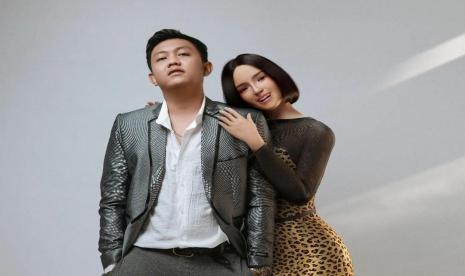 Penyanyi Denny Caknan (kiri) memperkenalkan platform musik dangdut baru bertajuk Ujung-Ujungnya Dangdut pada Agustus 2022. Platform musik dangdut itu dimodernisasi dan disenandungkan oleh virtual influencer (kanan).