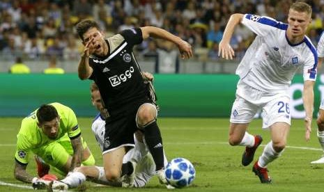 Penyerang Ajax Amsterdam Klaas Jan Huntelaar (tengah) terjatuh saat hendak mempertahankan bola menghadapi Dynamo Kiev pada play-off Liga Champions, Rabu (29/8) dini hari WIB.