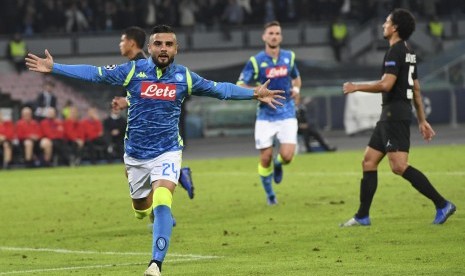 Penyerang Napoli Lorenzo Insigne merayakan keberhasilan menaklukkan kiper PSG Gianluigi Buffon dari titik putih.