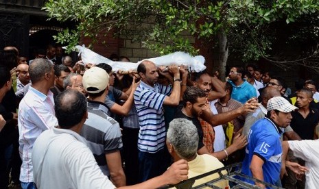 People carry a body during a funeral in Alexandria's Sidi Gaber district, Egypt, Saturday, July 6, 2013. The 18-year-old man was one of 14 who were killed Friday in a clash between supporters and opponents of Egypt's ousted President Mohammad Mursi. 