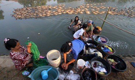 People wash clothes at the river in Karawang, West Java.   